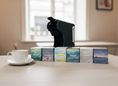 Load image into Gallery viewer, Tea boxes with a tea brewer on a table in a kitchen setting